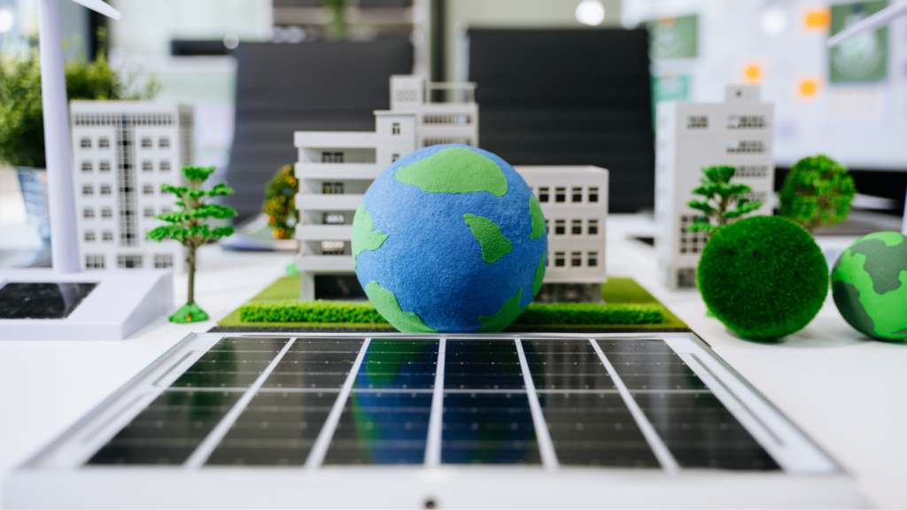 Miniature city scene with white buildings, a blue and green foam Earth in the center, and solar panels in the foreground